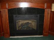 Drumm Design Remodel adds the last touches to this basement corner fireplace