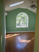 View of remodeled upstairs with new arched window, skylight and ceiling fan