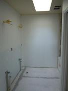 Drywall and plumbing fittings in new bathroom