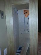 Inside of cabinet showing wiring, switches and base trim work