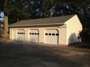 The new 3 car garage features doors with windows to provide more natural light in the space