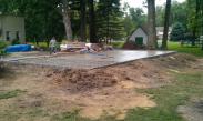 Pouring the concrete floor and smoothing the concrete with a large float