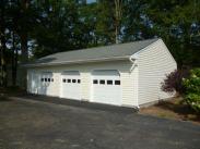 The paved three car garage side view