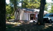 Drumm Design Remodeling finishing the siding on the new three car garage