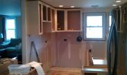 Drywall has been patched and the upper cabinets are being hung