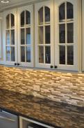 Glass front cabinets, granite countertops and undercabinet lighting make this Telford, PA kitchen shine