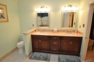 A clever half wall between the vanity and commode provides privacy in this spacious bathroom