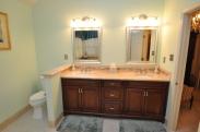 This double sink vanity gives the appearance of a fine piece of furniture in this master bath