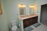 View of the commode and vanity from the corner tub