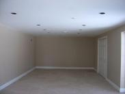 New usable space created by Drumm Design Remodel for a potential home theater, home gym or game room