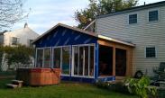 The walls are up, vapor barrier going around the sunroom and sliding glass doors are going into the room