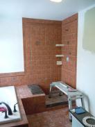 Working on finishing the shower in this stunning bathroom