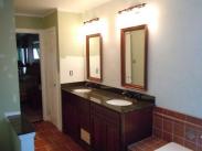 A beautiful new vanity looks like a piece of furniture plus the double mirrors accent the room nicely