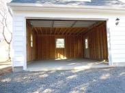 The view inside of this garage shows lots of space to park and work