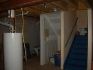 The existing hot water tank and an interesting storage space next to the stairs