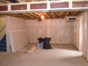 Framing with a vapor barrier added, plus boxing out the steel support beams