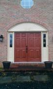 The new door has the look of wood but is really made of fiberglass