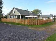 The completed backyard with cedar fencing and custom shed by Drumm Design Remodel