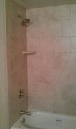 The new tile with corner soap dish and new faucet, spigot and shower head