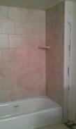 The back side of the shower with corner soap dish, notice the wall has been repaired to enable the shower door and bath to fit properly
