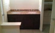 The new vanity in place with the doors, sinks, and countertop in place