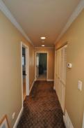 A view of the new improved hallway and crown moulding by Drumm Design Remodel