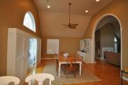 A view from the family room of the new arched entry into the dining room by Drumm Design Remodel