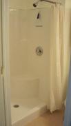 The new powder room shower stall installation by Drumm Design Remodel