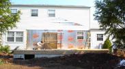 Laying the floor joists and removing the old siding to make way for the new addition