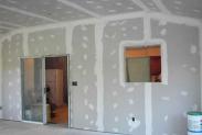 Wrapping up the drywall work, notice the high ceilings in this space