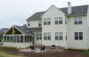 The new screened porch flows seamlessly into the home and patio