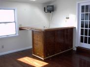 Hardwood floors and a bar make this room terrific