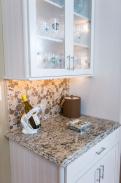 Glass front cabinets, an amazing back splash and granite countertops with detailed edges make this kitchen stand out!