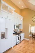 Lots of storage space and a hidden refrigerator and freezer in this kitchen by Drumm Design Remodel