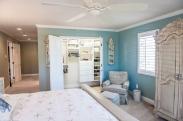 A sweeping view of the entire master bedroom and down the hall to the master bathroom