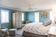 A view of this bright and airy Master bedroom from the hallway and office