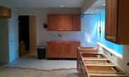 Kitchen cabinets on far wall ready for countertops.