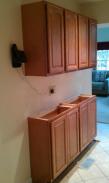 Far end of kitchen cabinets installed, lots of storage space!