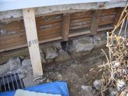 Exterior wall brace supports foundation