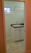 View of the sink, new window and laundry hanging rack
