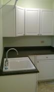 A large laundry sink and cabinets for the family